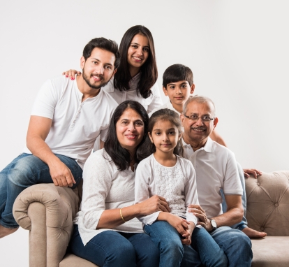 An Indian immigrated to Canada family sitting on sofa
